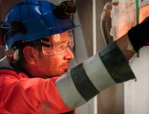 A Veolia employee looks into an industrial process